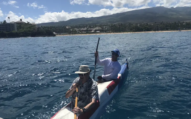 Two paddlers in an outrigger canoe off Kāʻanapali
