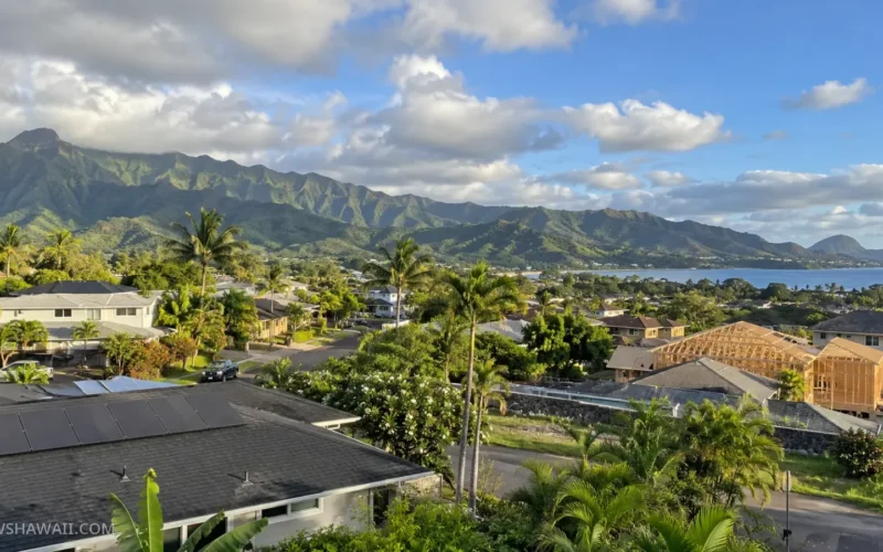 Hawaiʻi neighborhood rooftops and new home construction below green mountains