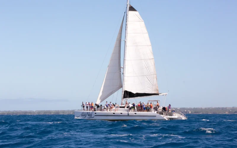 Sailing catamaran full of visitors off Maui