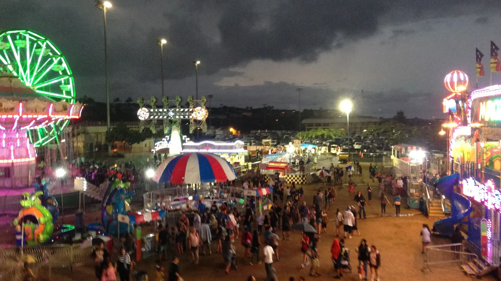 Crowds and carnival rides at the Maui Fair at night