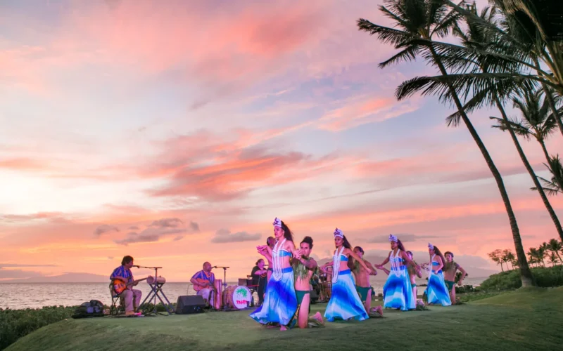 Hula dancers and musicians performing at sunset in Wailea, Maui